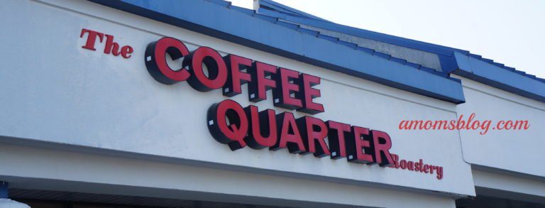 A sign that says coffee quarter on the side of a building.