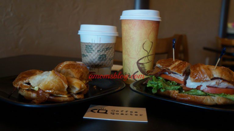 A table with two plates of food and coffee.