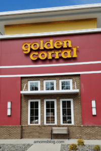 A red building with the words " golden corral ".