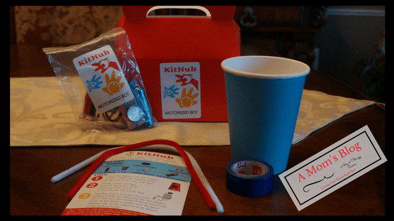 A cup and some papers on top of a table.