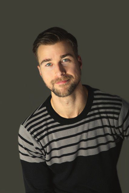 A man with a beard and striped shirt