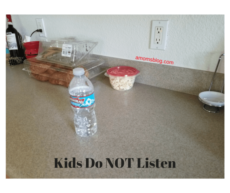 A bottle of water and some food on the counter.