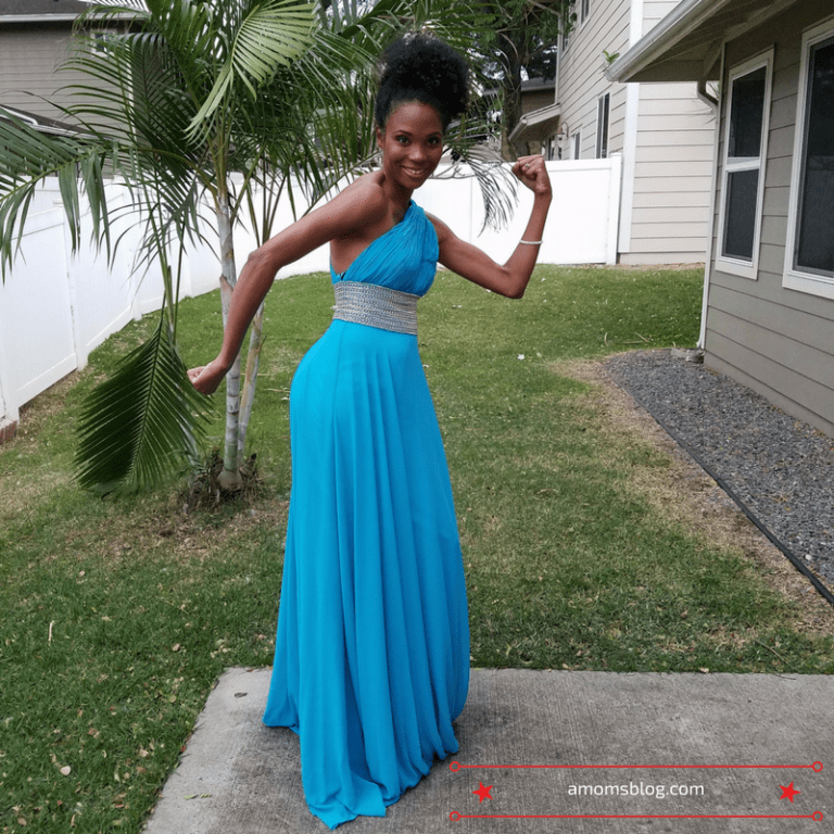 A woman in a blue dress posing for the camera.