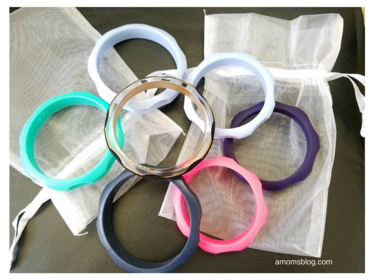 A group of six different colored bracelets sitting on top of a table.