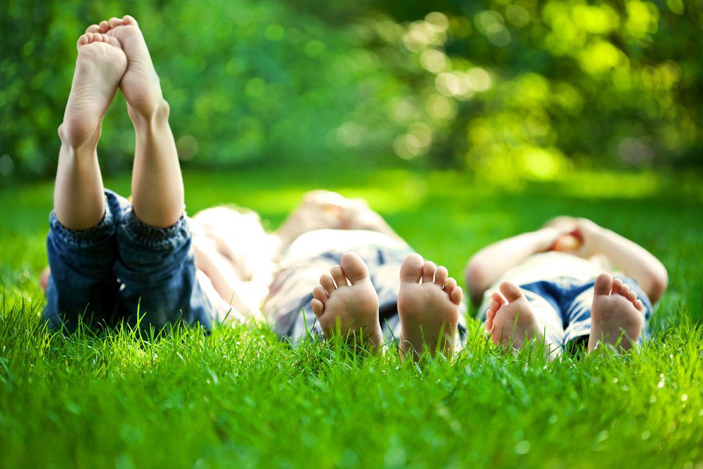 A group of people laying in the grass.
