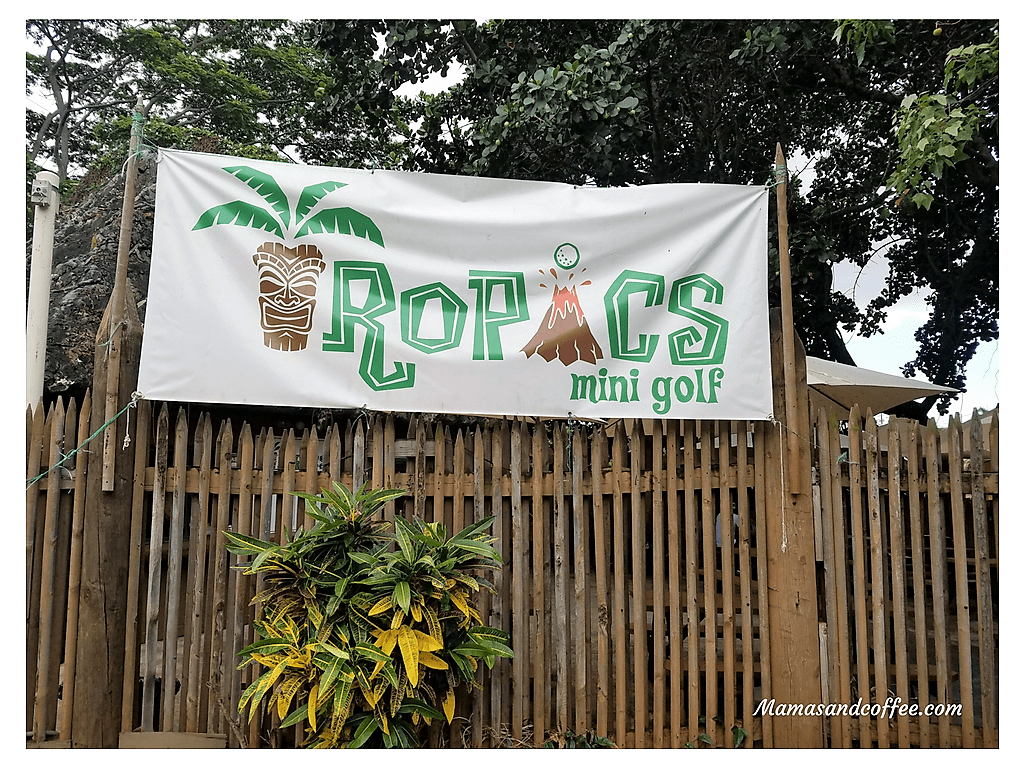 A sign hanging on the side of a fence.