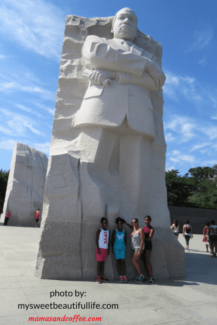 A group of people standing next to the martin luther king jr. Memorial