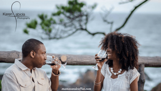 A man and woman drinking wine at the beach