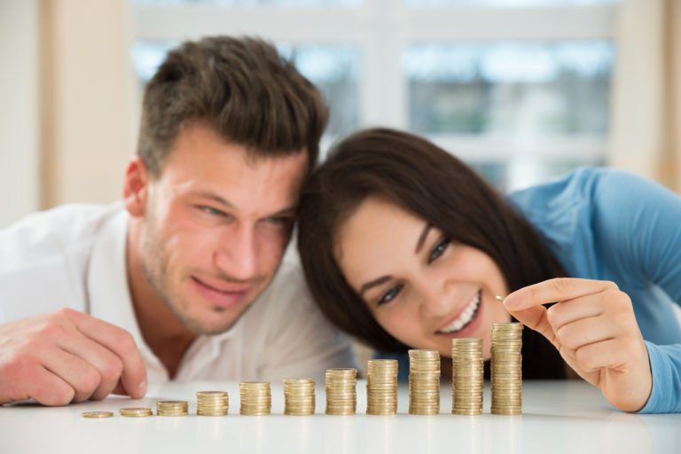 A man and woman are playing with stacks of coins.