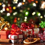 A table topped with lots of christmas presents.