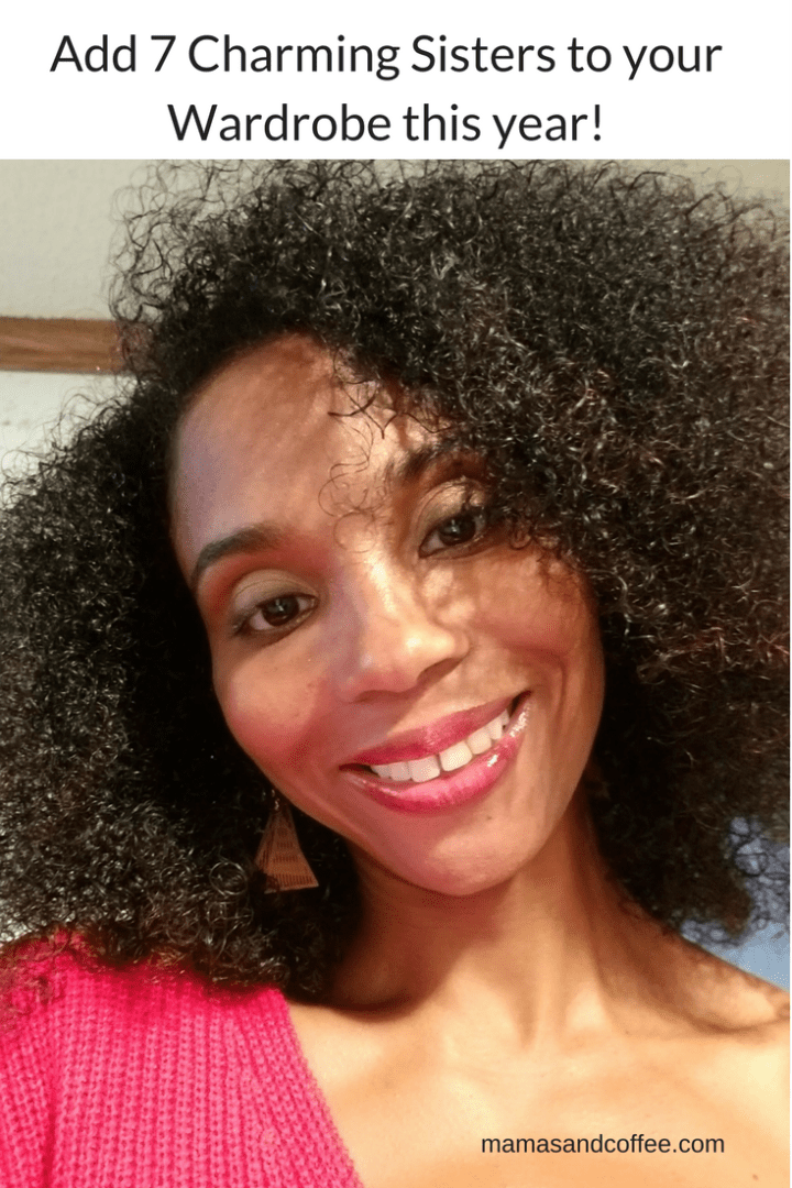 A woman with curly hair smiling for the camera.