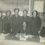 A group of women in uniform posing for the camera.