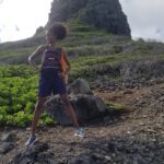 A person running on the side of a mountain
