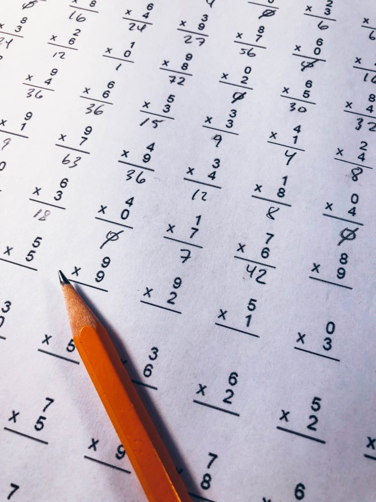 A pencil sitting on top of an exam paper.