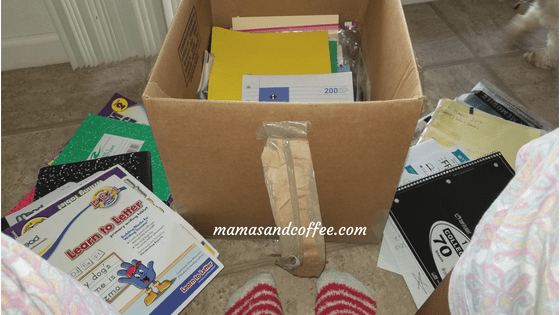 A box of books and papers on the floor