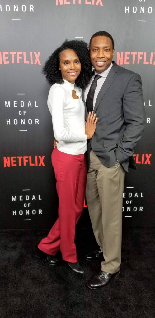 A man and woman posing for a picture at the netflix event.