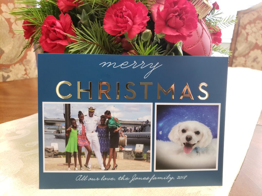 A christmas card with two photos of the same family.