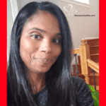 A woman with long black hair is smiling.