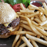 A hamburger and fries are on the table.