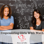 Two girls are posing for a picture in front of a chalkboard.
