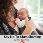 A woman holding a baby in her arms.