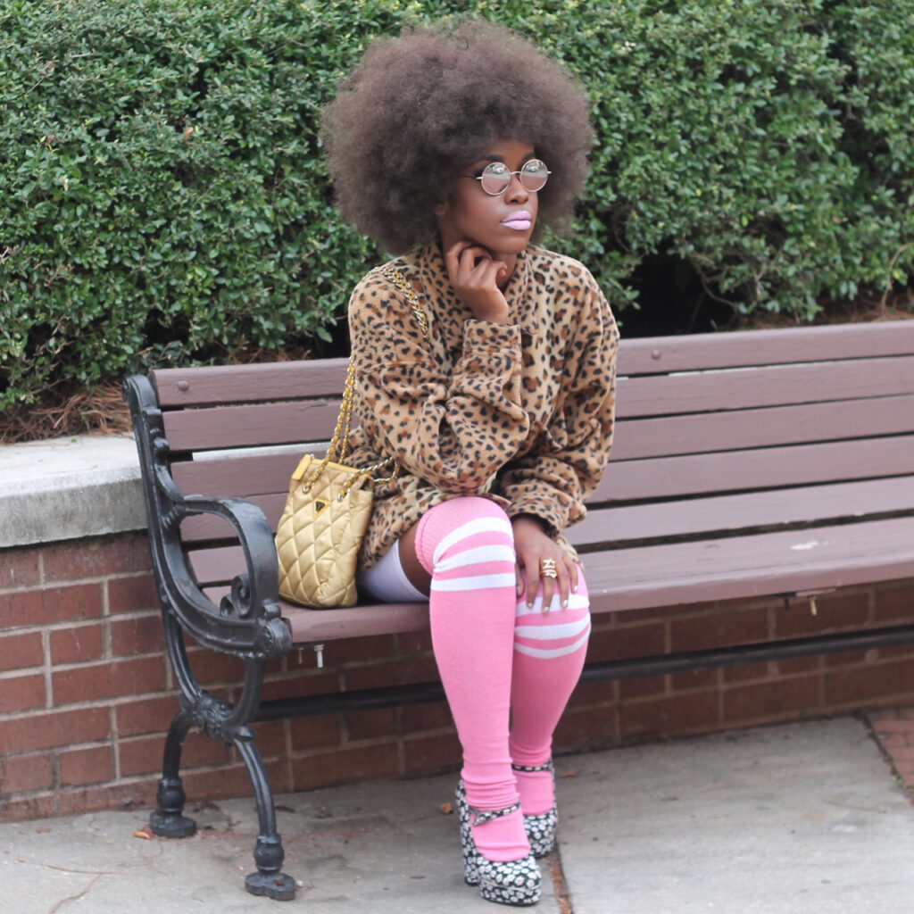 A person sitting on a bench wearing pink socks