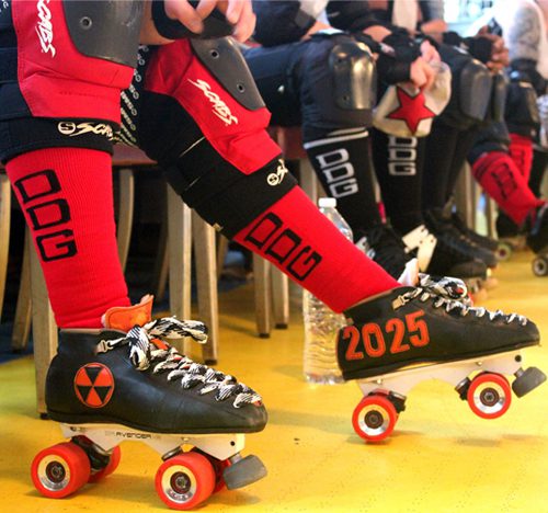 A person wearing roller blades and red socks.