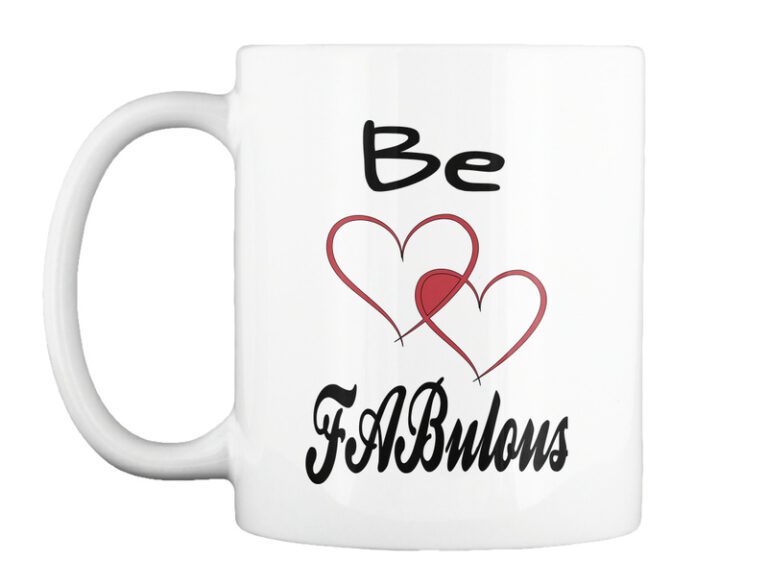 A white mug with the words be fabulous written in black and red.
