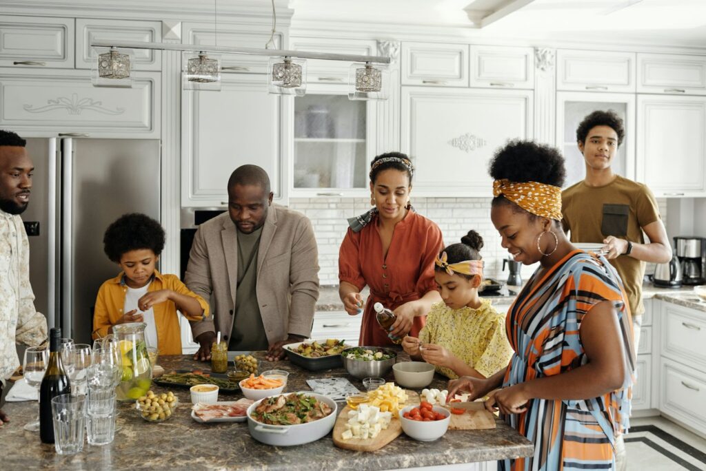 A group of people standing around a kitchen counter.