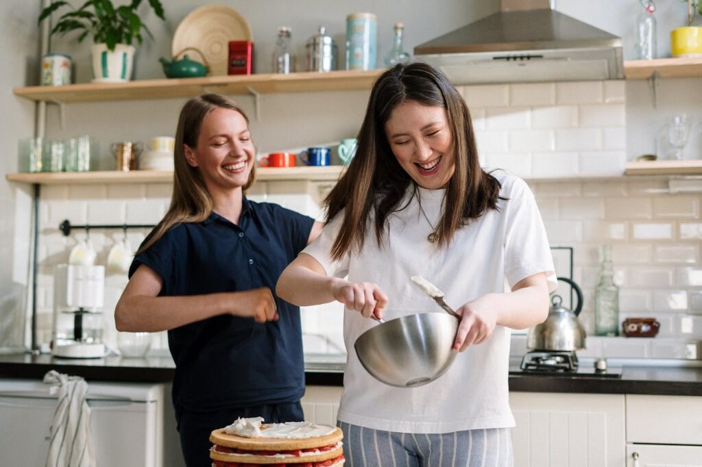 A woman in an apron is cooking on the stove